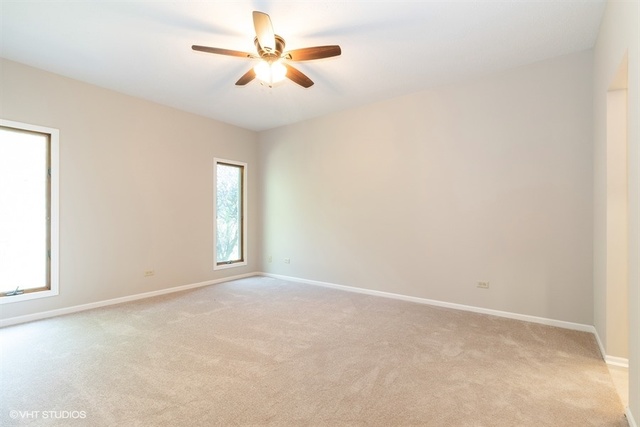 154 Bent Tree Lane New Lenox, IL 60451 - Photo 15 of 25 an empty room with windows and fan