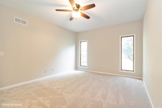 154 Bent Tree Lane New Lenox, IL 60451 - Photo 16 of 25 an empty room with windows and fan