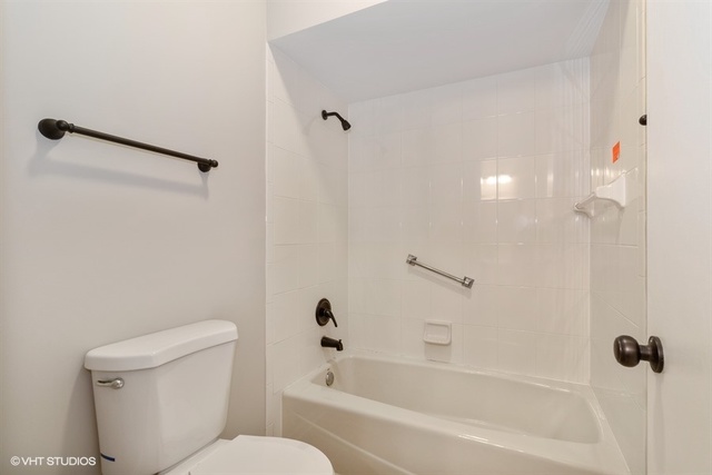 154 Bent Tree Lane New Lenox, IL 60451 - Photo 19 of 25 a white bath tub sitting next to a toilet