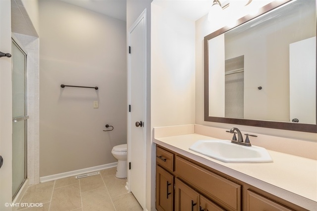 154 Bent Tree Lane New Lenox, IL 60451 - Photo 20 of 25 a bathroom with a sink a toilet a shower and a mirror
