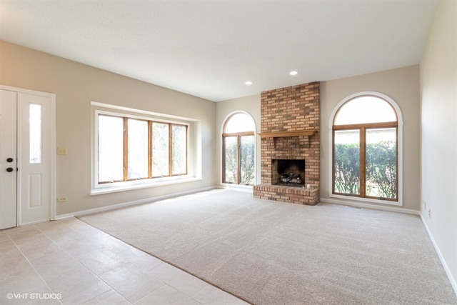154 Bent Tree Lane New Lenox, IL 60451 - Photo 3 of 25 an empty room with windows and fireplace