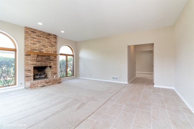 154 Bent Tree Lane New Lenox, IL 60451 - Photo 4 of 25 an empty room with windows and fireplace