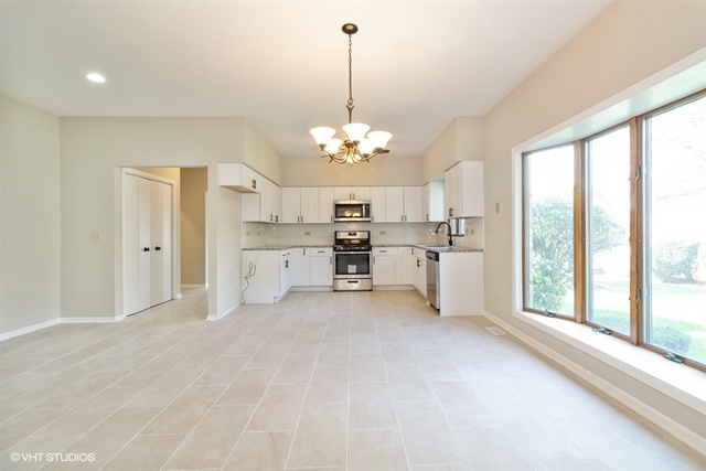 154 Bent Tree Lane New Lenox, IL 60451 - Photo 6 of 25 a view of a kitchen with refrigerator and window