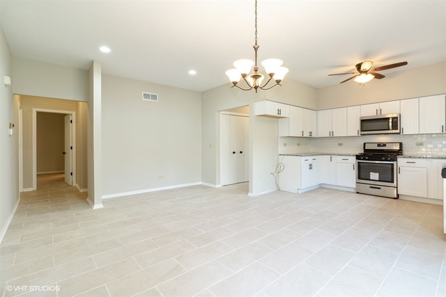 154 Bent Tree Lane New Lenox, IL 60451 - Photo 7 of 25 a view of a kitchen with stainless steel appliances kitchen island and a refrigerator