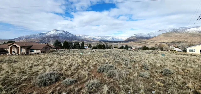 a view of a house with a yard and sitting area
