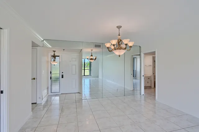a kitchen with stainless steel appliances granite countertop white cabinets and a sink