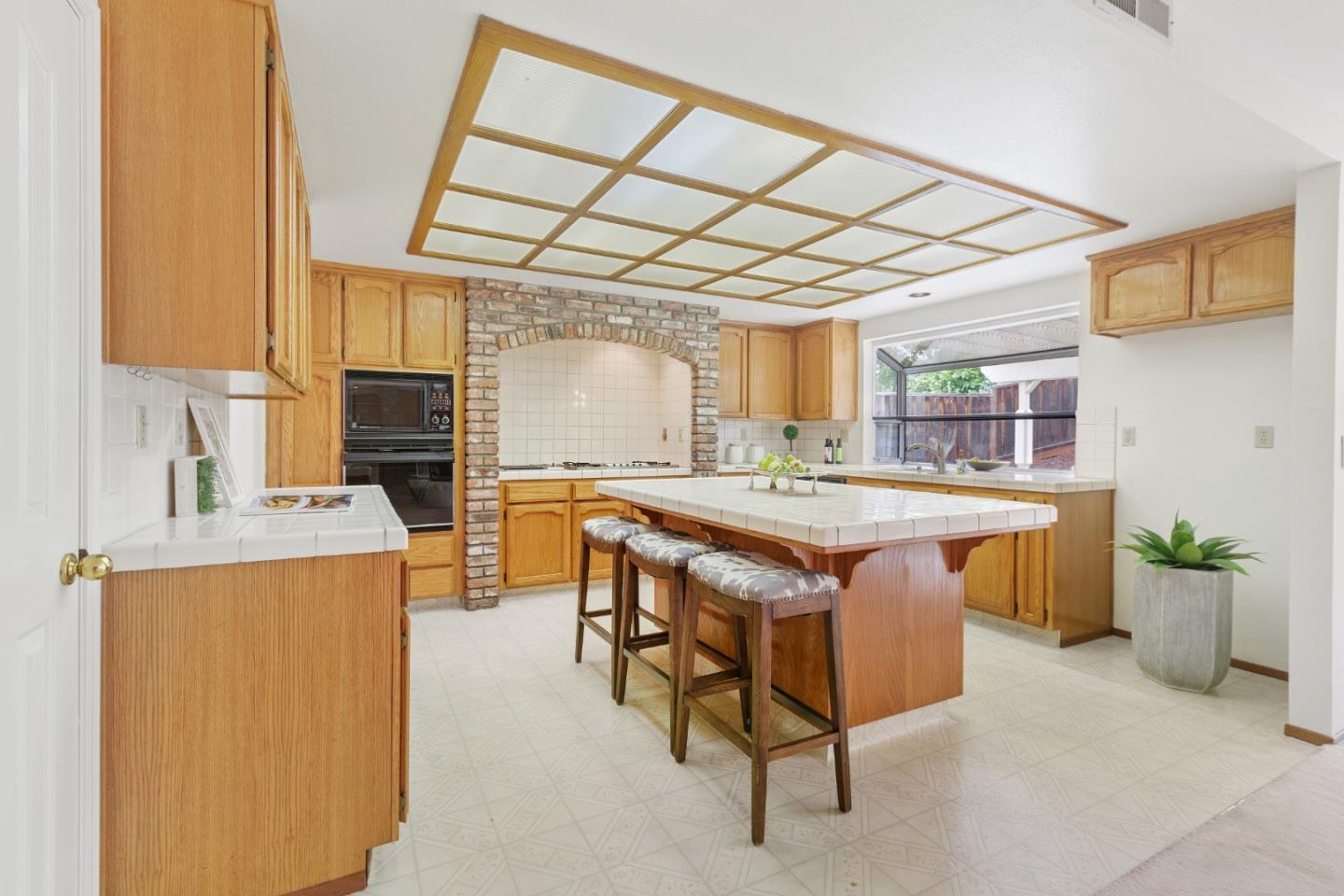 2018 Skyline Drive Milpitas, CA 95035 - Photo 6 of 22 a kitchen with a stove a refrigerator and a wooden cabinets