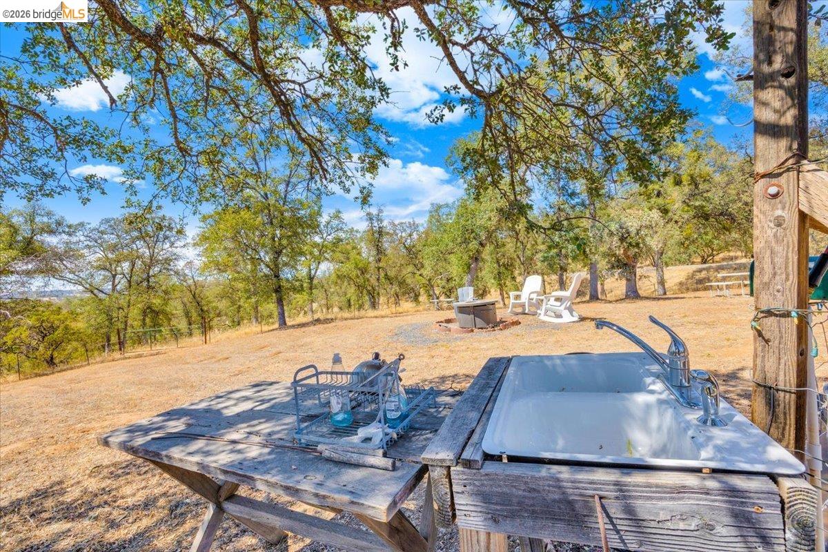 14450 Jacksonville Road Jamestown, CA 95327 - Photo 77 of 85 Outdoor sink with dual faucets, surrounded by mature trees and natural terrain