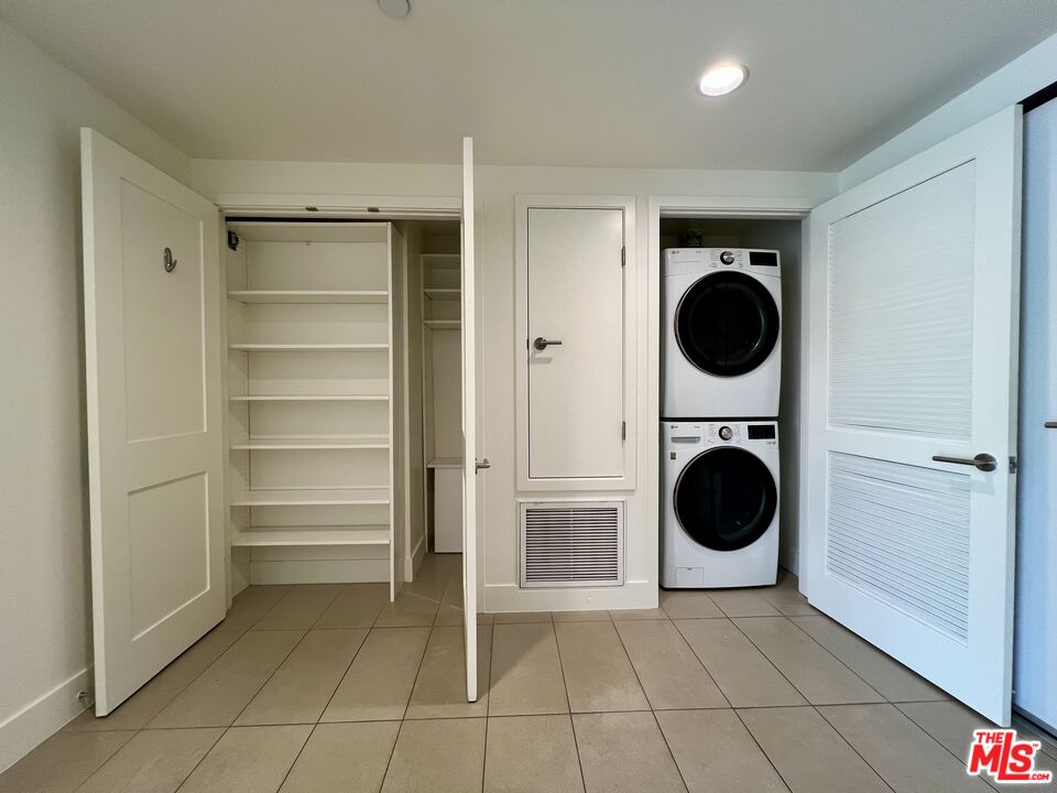 11715 Bellagio Road, Unit 204 Los Angeles, CA 90049 - Photo 16 of 27 a view of a hallway with washer and dryer