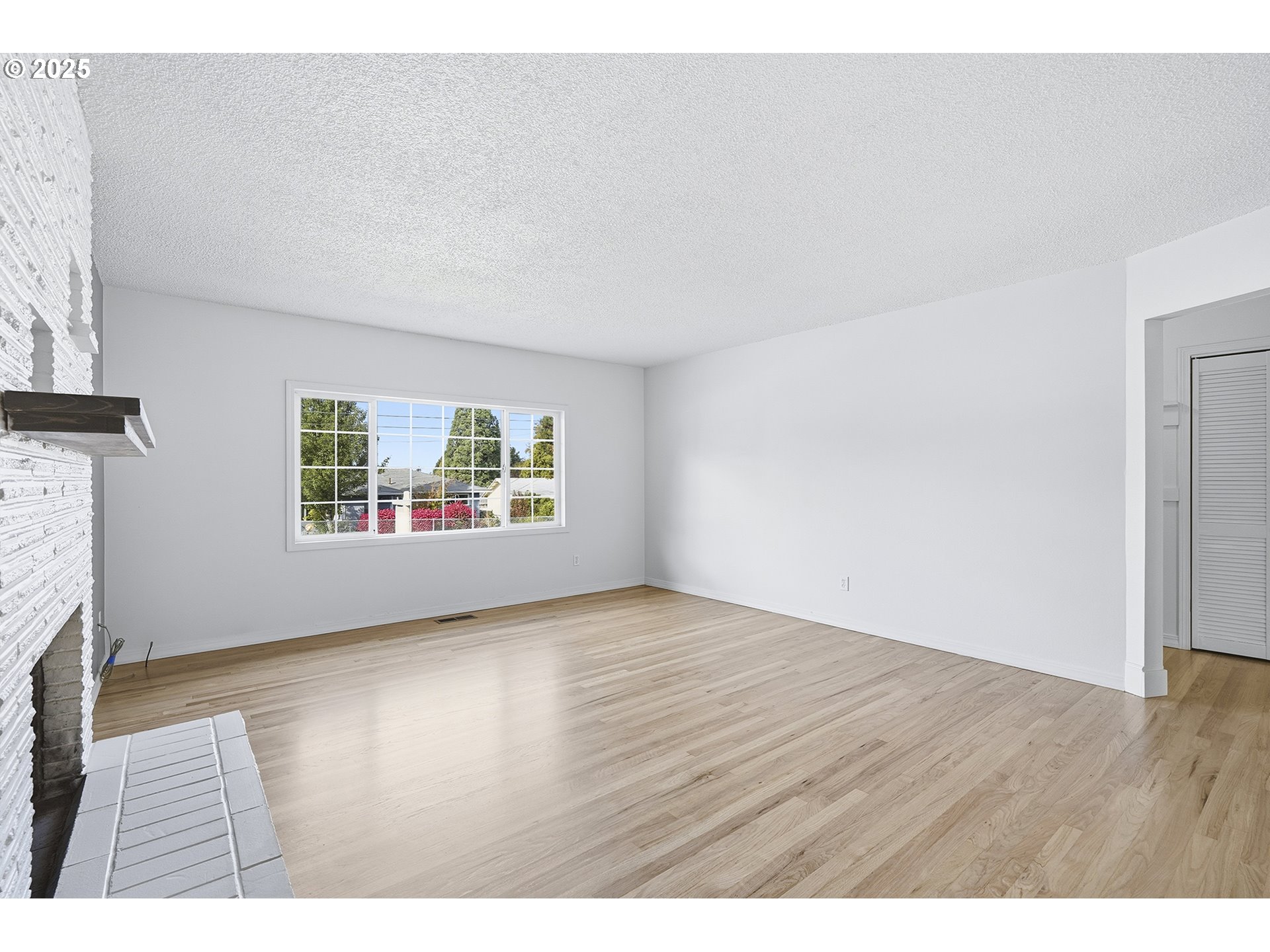 1422 Southeast 209th Avenue Gresham, OR 97030 - Photo 13 of 46 an empty room with wooden floor wooden floor and windows