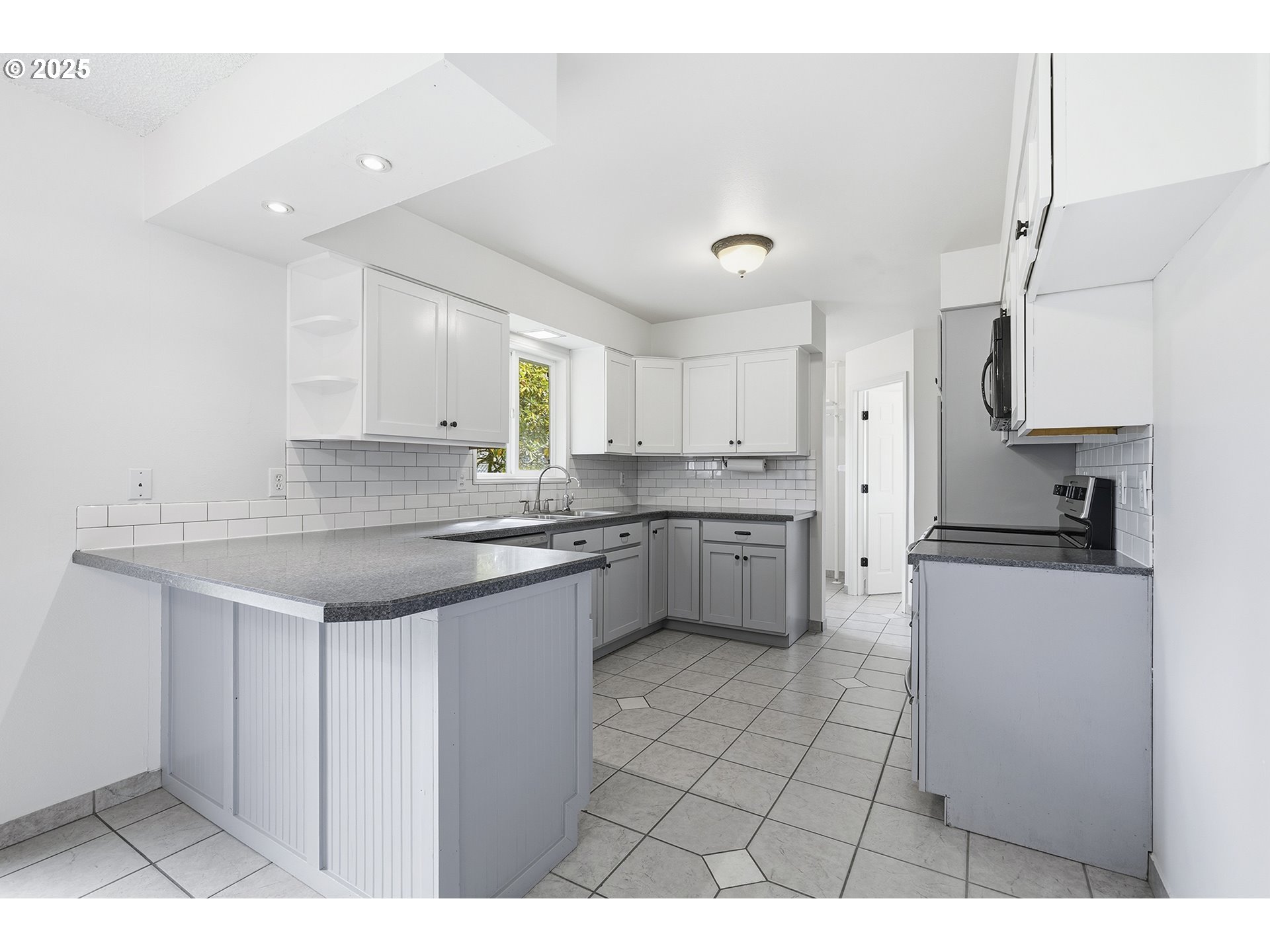 1422 Southeast 209th Avenue Gresham, OR 97030 - Photo 19 of 46 a kitchen with a sink window and cabinets
