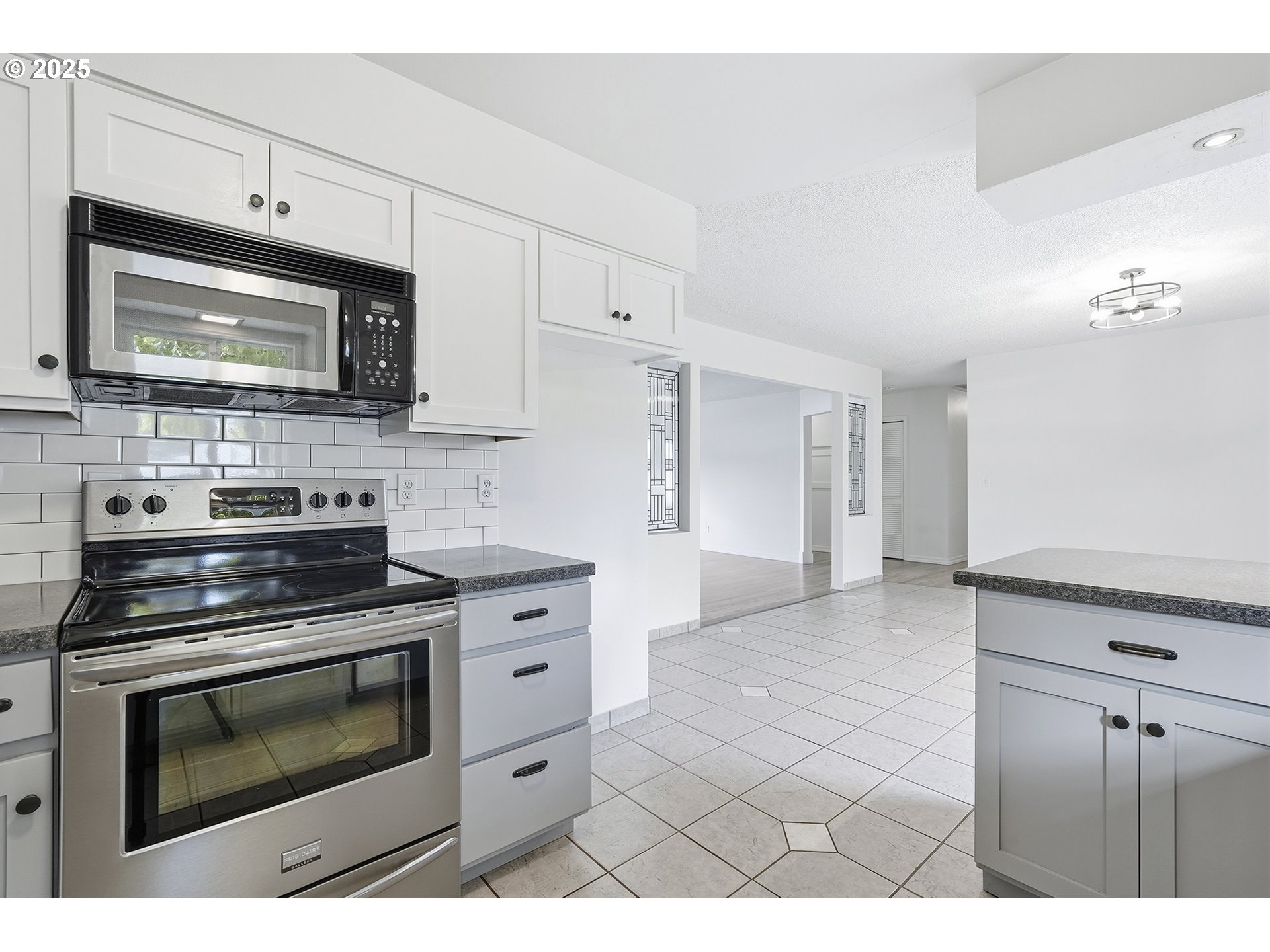 1422 Southeast 209th Avenue Gresham, OR 97030 - Photo 21 of 46 a kitchen with stainless steel appliances a stove a microwave and cabinets