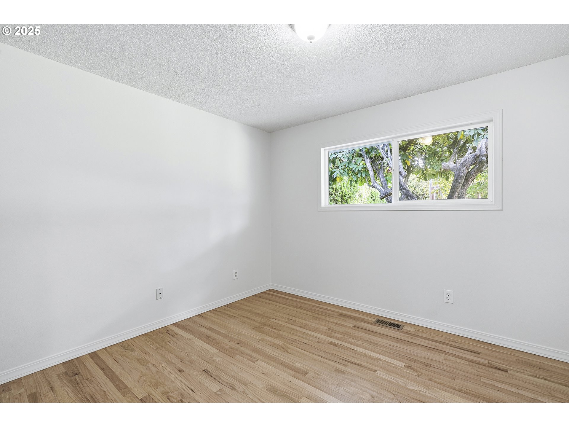 1422 Southeast 209th Avenue Gresham, OR 97030 - Photo 34 of 46 an empty room with wooden floor and windows