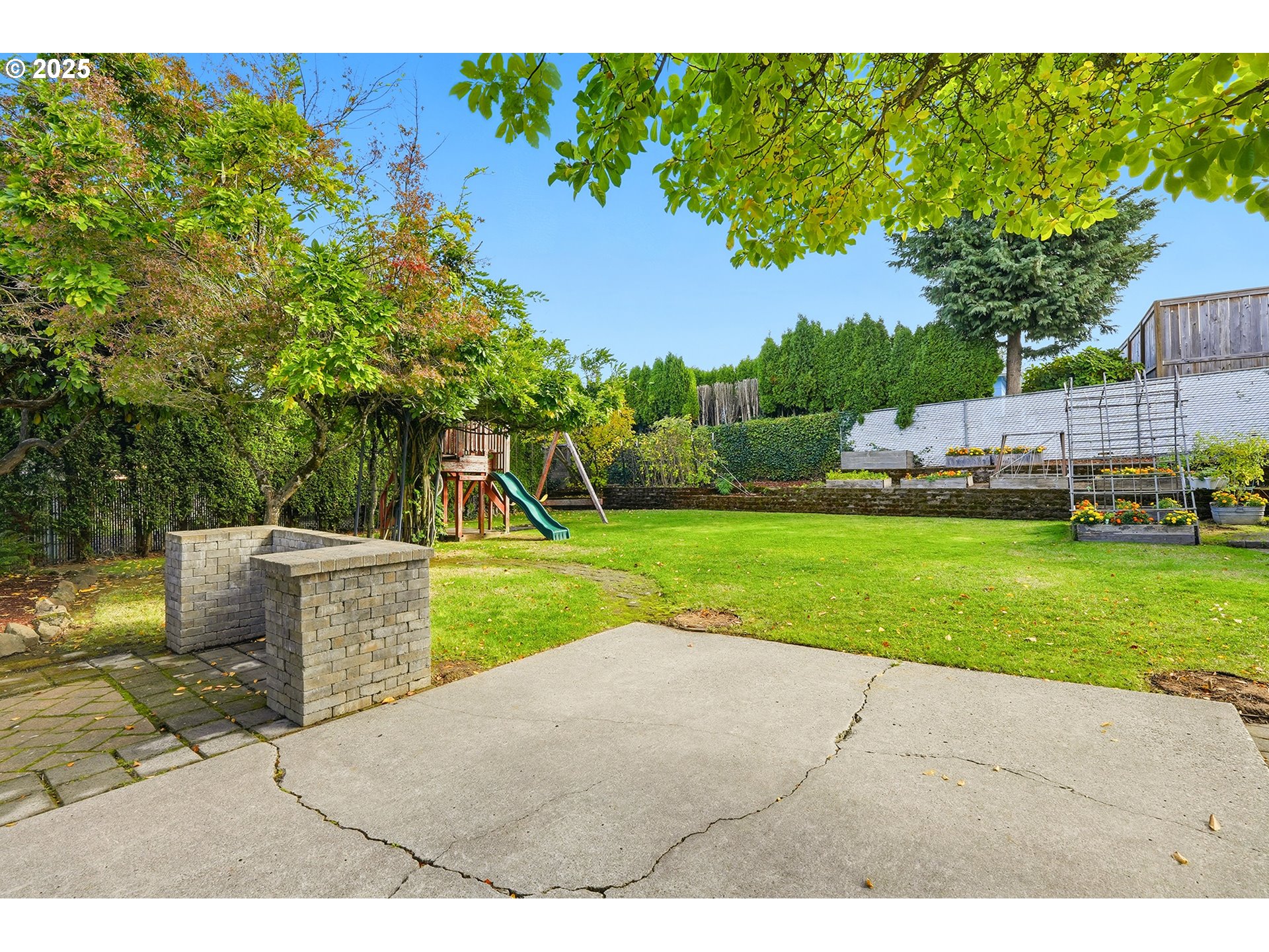 1422 Southeast 209th Avenue Gresham, OR 97030 - Photo 39 of 46 a view of a backyard with a garden and fire pit
