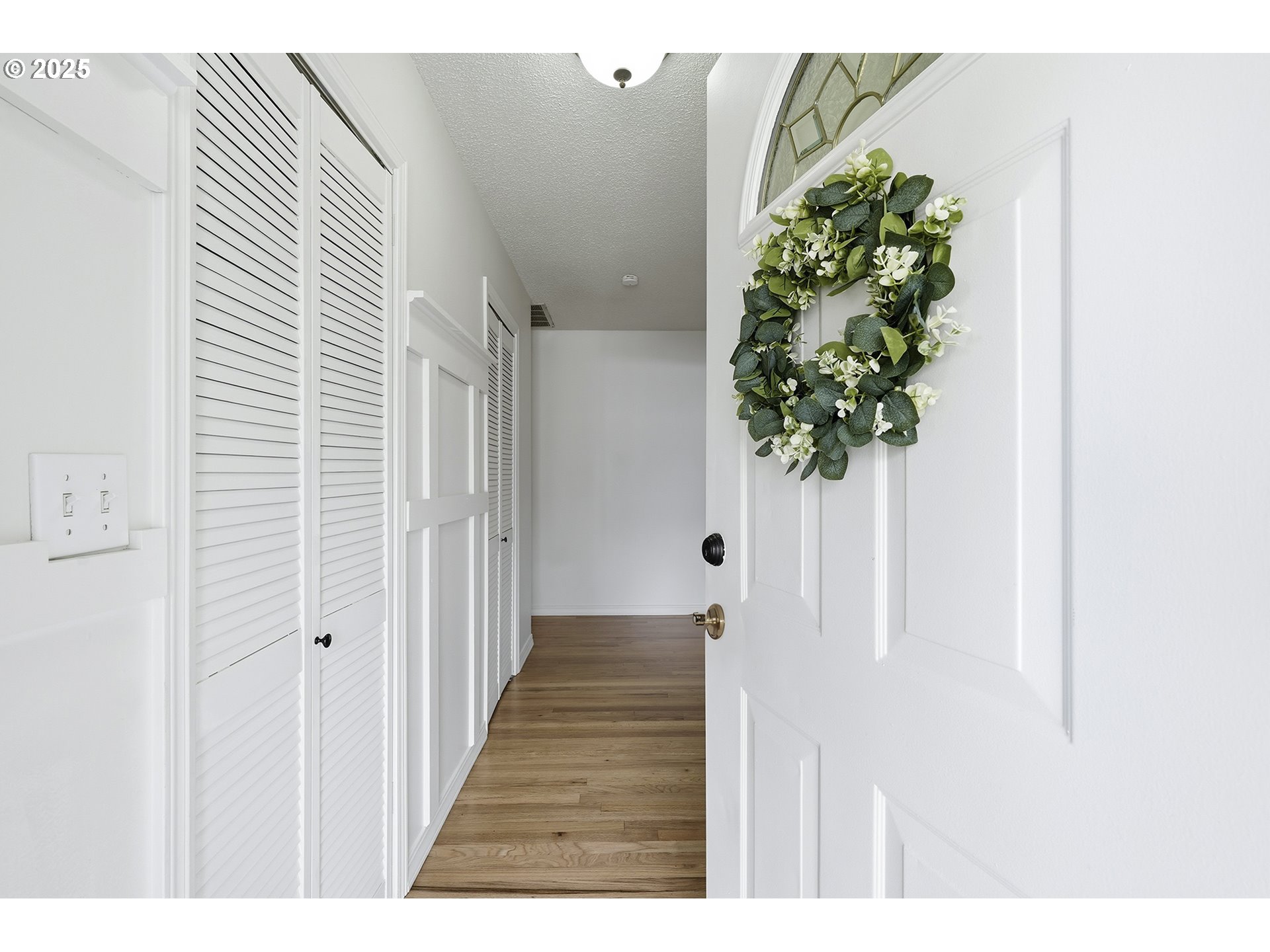 1422 Southeast 209th Avenue Gresham, OR 97030 - Photo 4 of 46 a view of a hallway with wooden floor and a potted plant