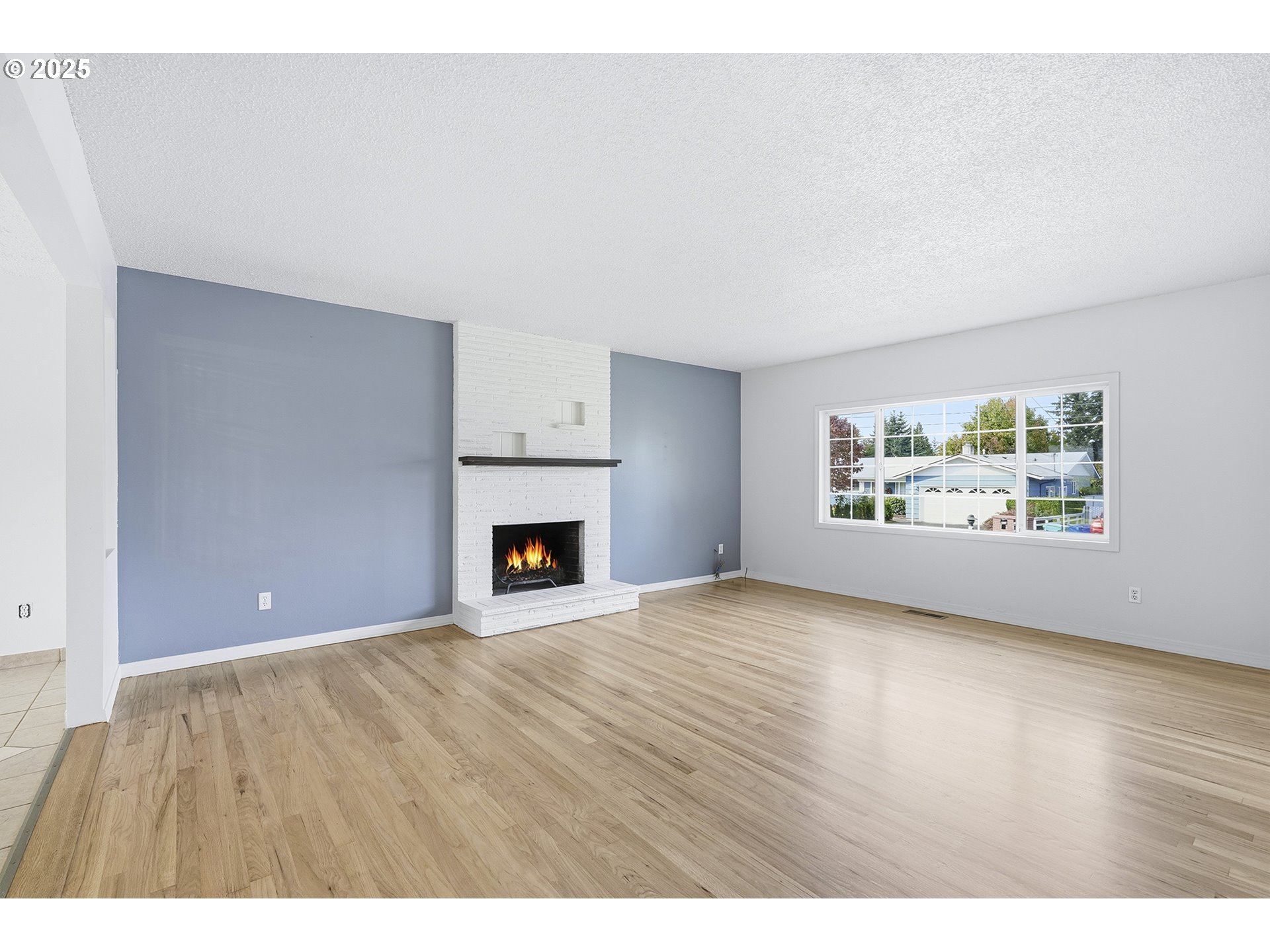 1422 Southeast 209th Avenue Gresham, OR 97030 - Photo 7 of 46 a view of an empty room with a window and fireplace