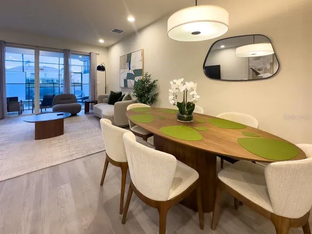 a view of a dining room with furniture and wooden floor