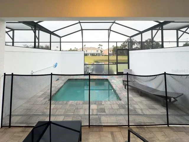 a view of a hallway with furniture and a window