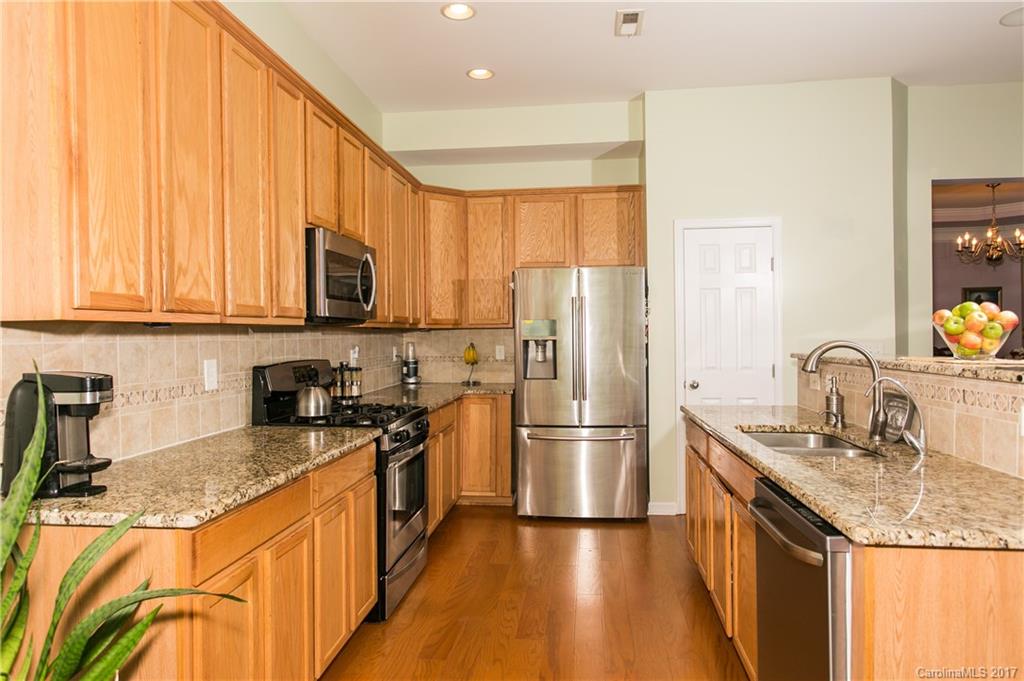 7123 Meyer Road, Unit 263 Fort Mill, SC 29715 - Photo 8 of 24 a kitchen with stainless steel appliances granite countertop a sink stove and refrigerator