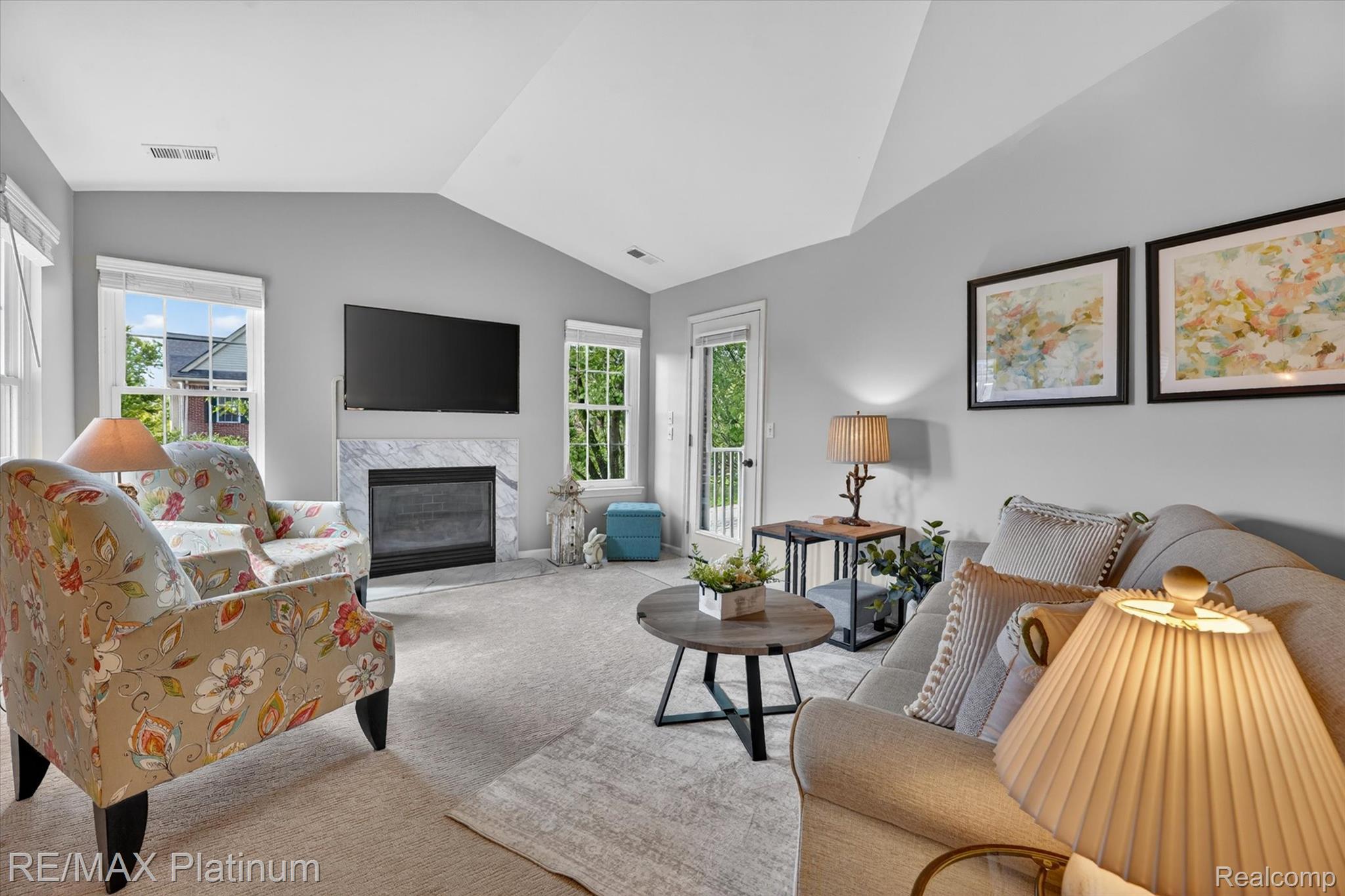 4191 Hampton Ridge Boulevard, Unit 41 Howell, MI 48843 - Photo 3 of 23 Living area featuring vaulted ceiling, carpet, and a premium fireplace