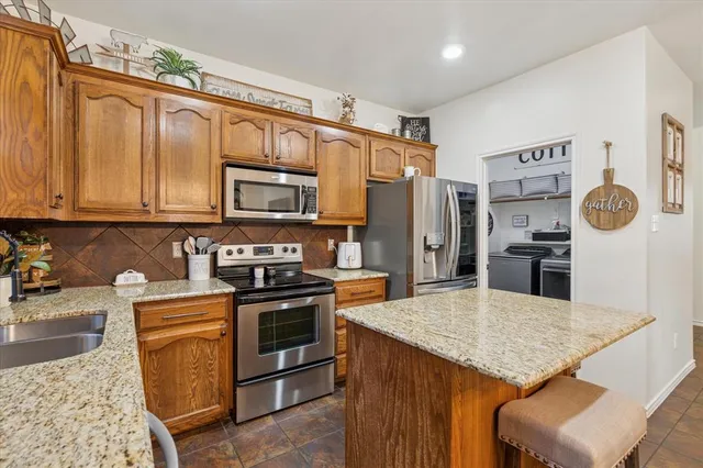 a bedroom with a bed couch and window