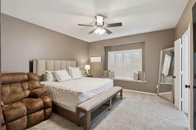 a bedroom with a bed couch and window