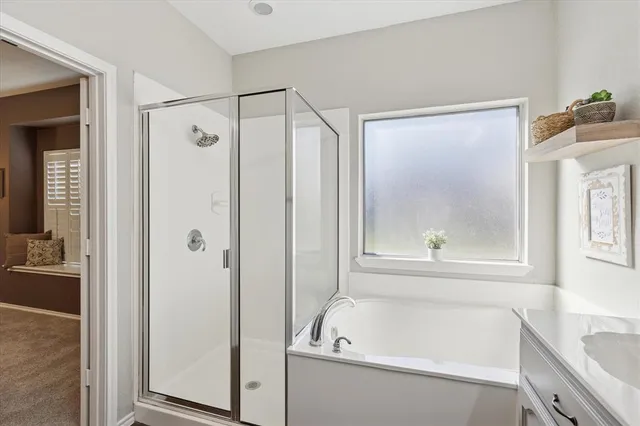 a bathroom with a tub sink and mirror