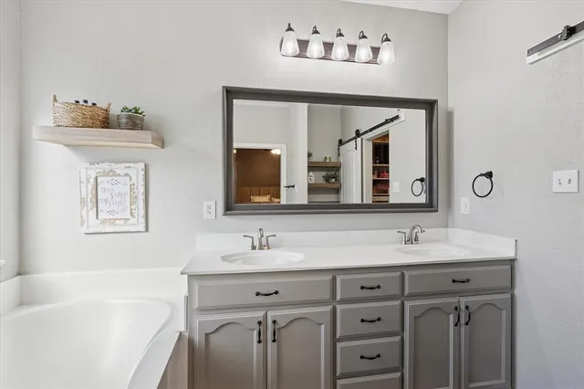 a bathroom with a sink and mirror