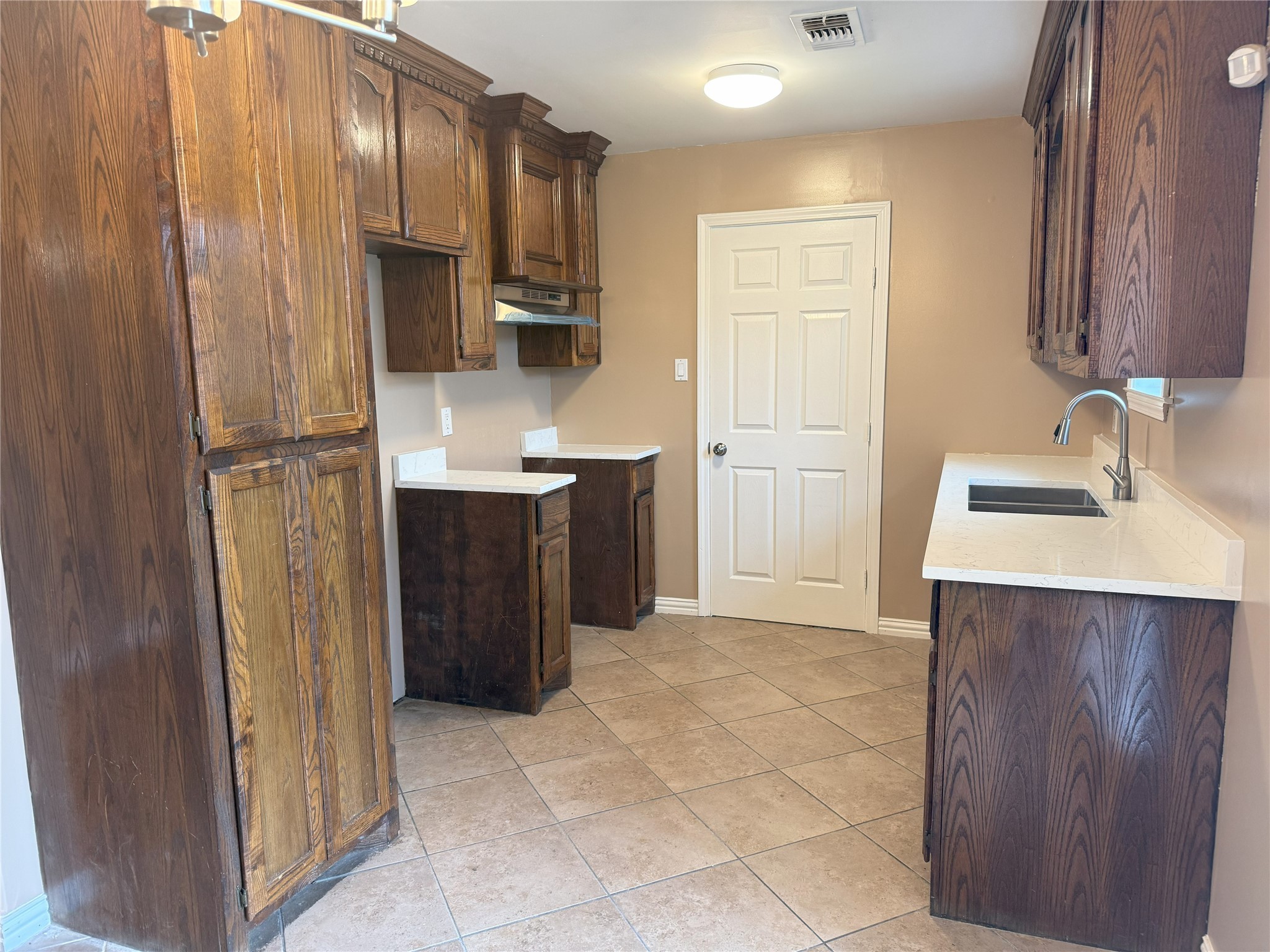 12727 Zavalla Street Houston, TX 77085 - Photo 3 of 8 a kitchen with a sink refrigerator and cabinets