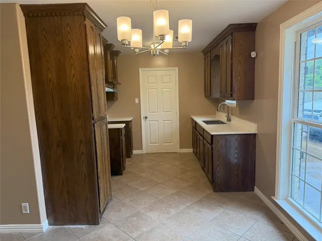 a spacious bathroom with a mirror a sink and shower