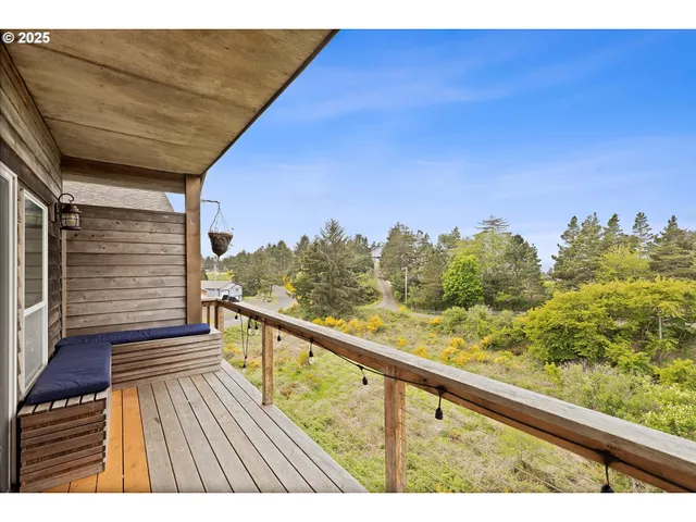 a view of balcony with wooden floor and fence