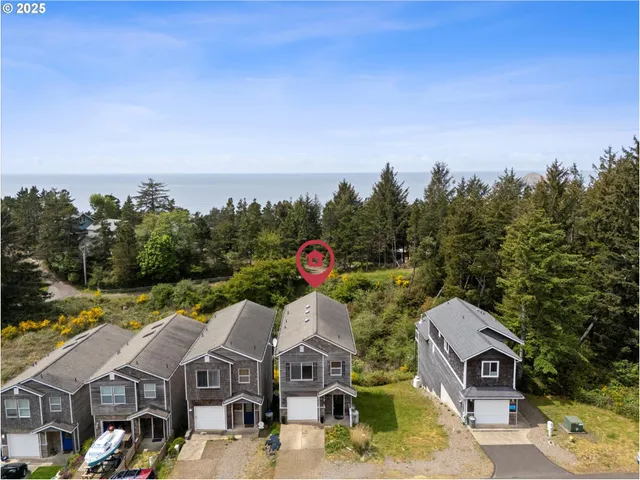 a aerial view of a house with a big yard and large tree