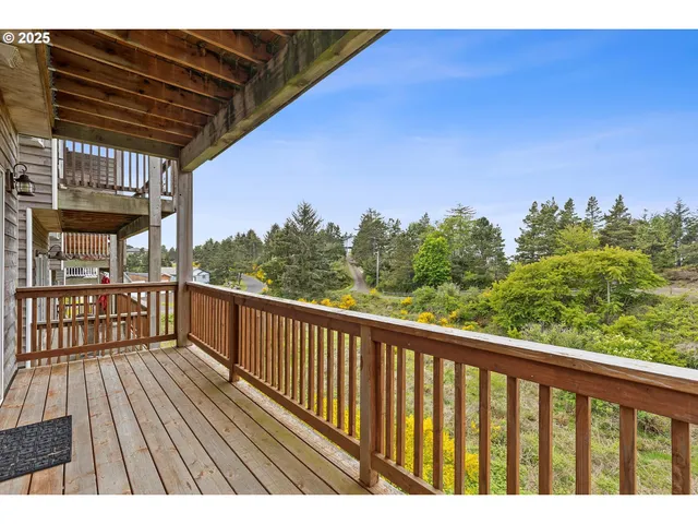 a view of balcony with wooden floor and fence
