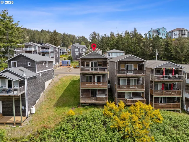a front view of a residential apartment building with a yard