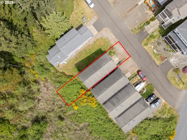 an aerial view of a house with a yard and garden