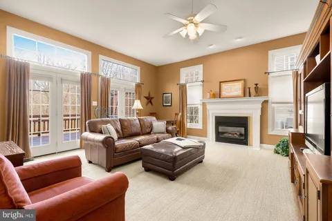 a living room with furniture a large window and a fireplace