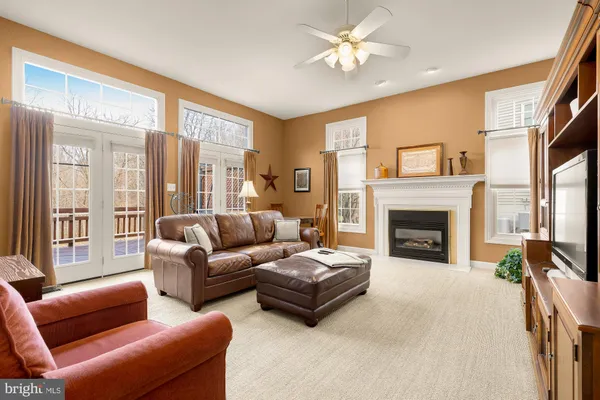a living room with furniture a large window and a fireplace