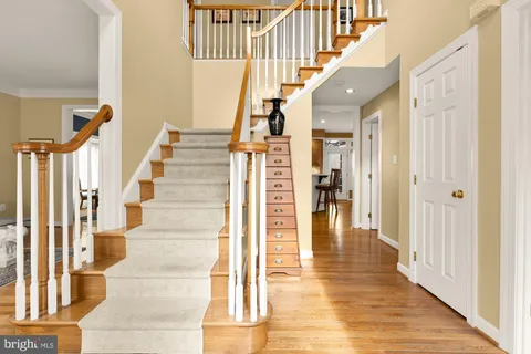 a view of entryway and hall with wooden floor