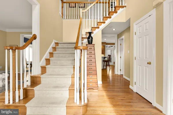 a view of entryway and hall with wooden floor