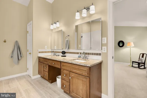 a bathroom with a double vanity sink mirror and
