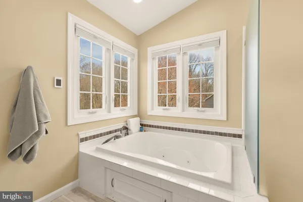 a bath tub sitting next to a window