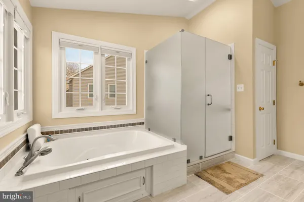 a bathroom with a tub and a shower