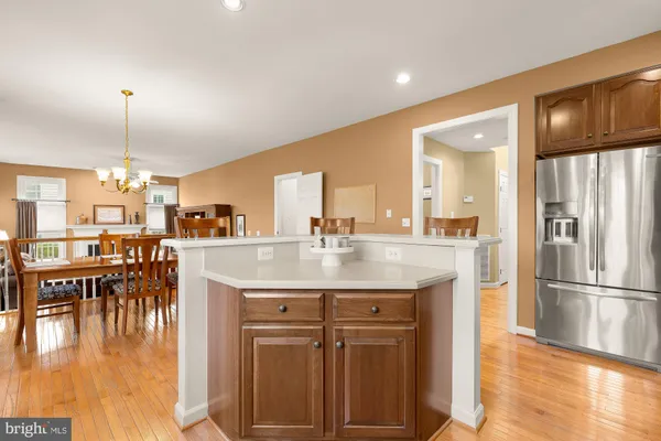 a view of a kitchen with furniture and wooden floor