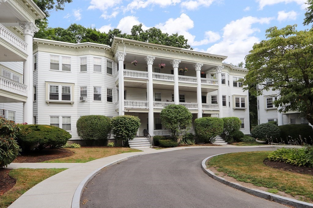 138 Middlesex Road, Unit B Newton, MA 02467 - Photo 1 of 16 a front view of a house with a yard