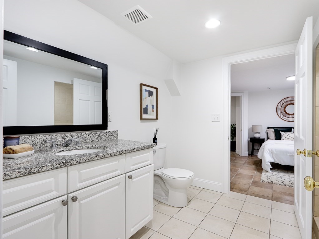 138 Middlesex Road, Unit B Newton, MA 02467 - Photo 14 of 16 a bathroom with a toilet sink and mirror
