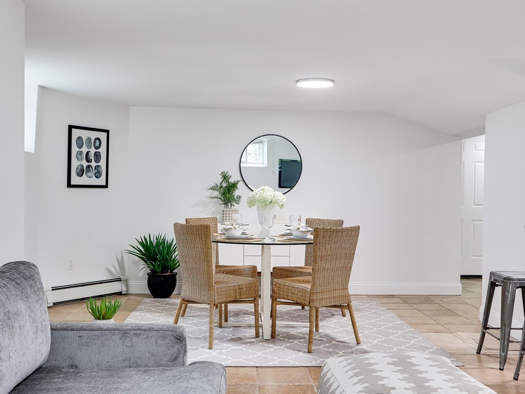 138 Middlesex Road, Unit B Newton, MA 02467 - Photo 4 of 16 a view of a dining room with furniture and table potted plants