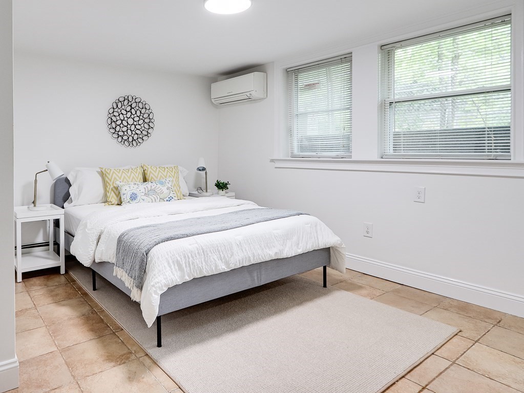 138 Middlesex Road, Unit B Newton, MA 02467 - Photo 8 of 16 a bedroom with a bed and a window