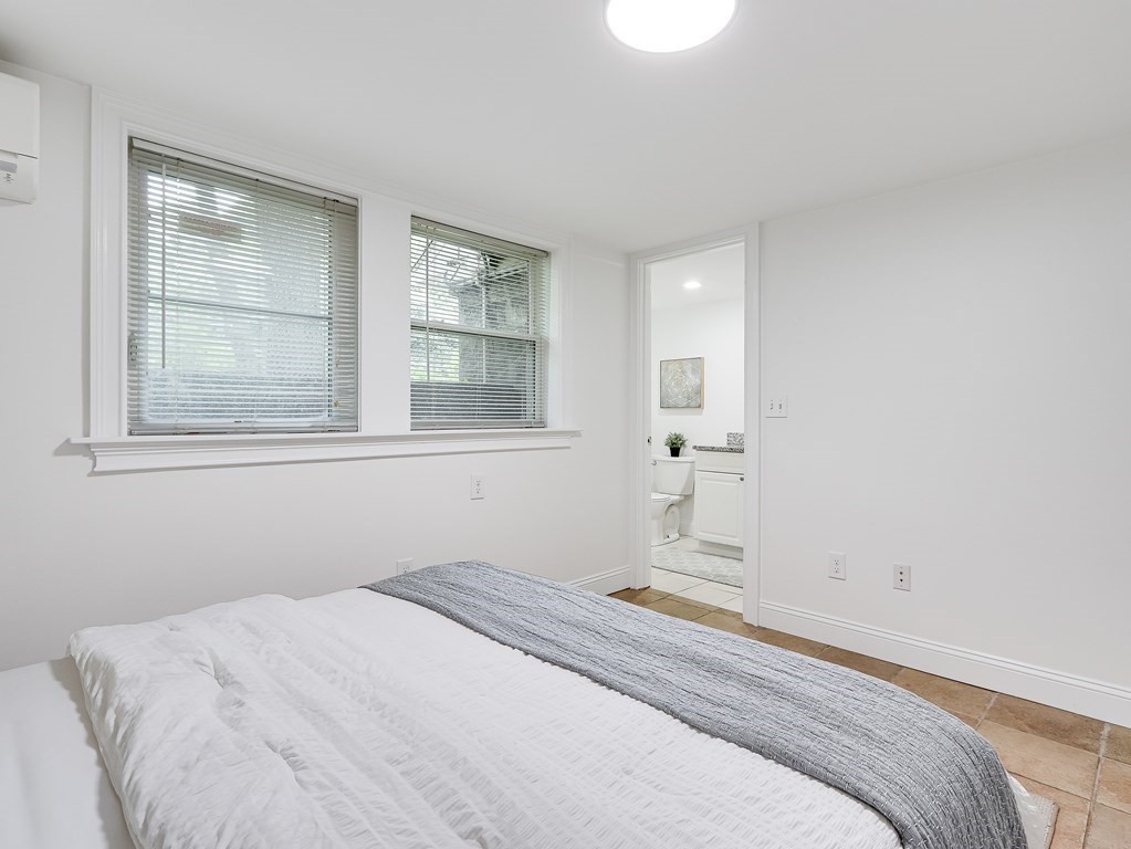 138 Middlesex Road, Unit B Newton, MA 02467 - Photo 9 of 16 a bedroom with a bed and a window