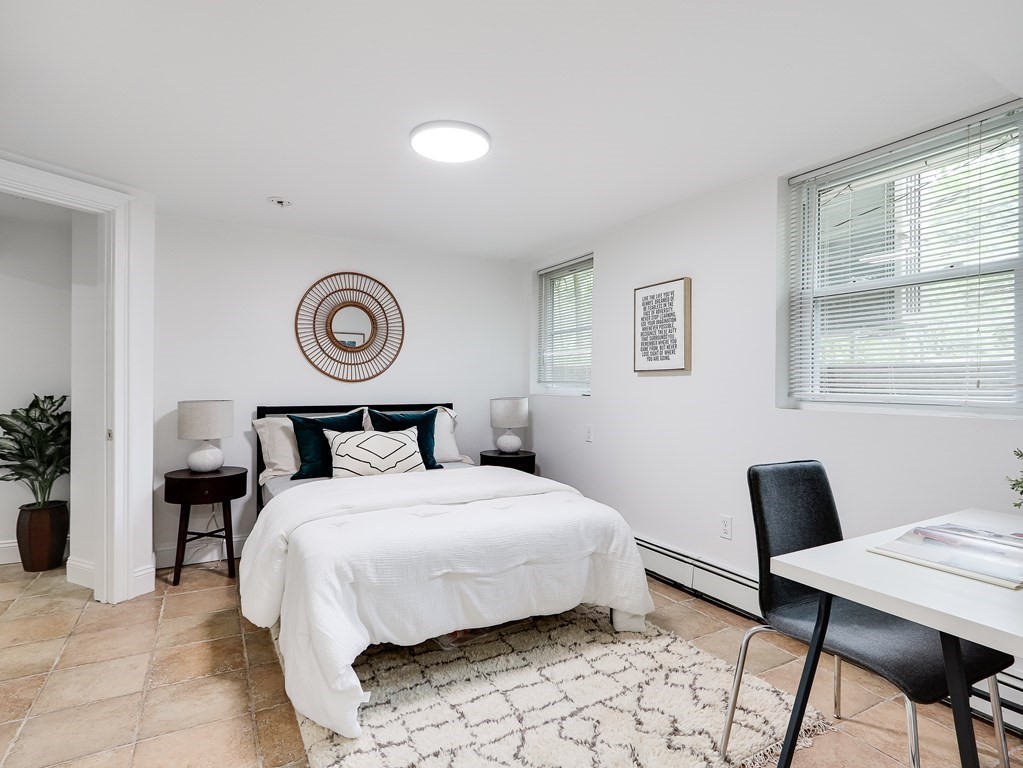 138 Middlesex Road, Unit B Newton, MA 02467 - Photo 10 of 16 a bedroom with a bed and a chandelier