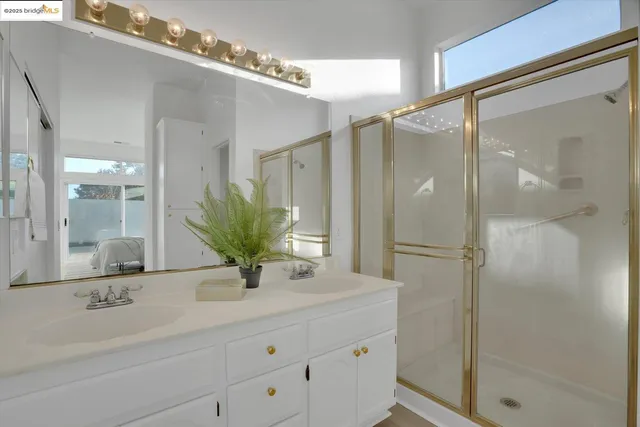 a bathroom with a shower sink and mirror